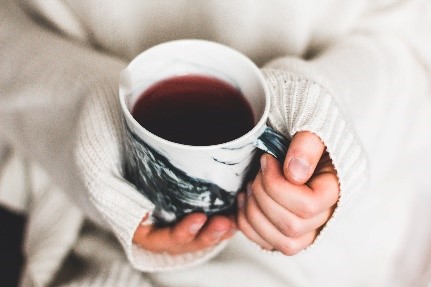 Tight cup of coffee in woman's hands