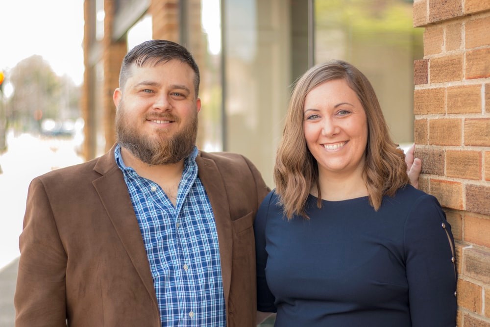 Husband and wife smiling at camera